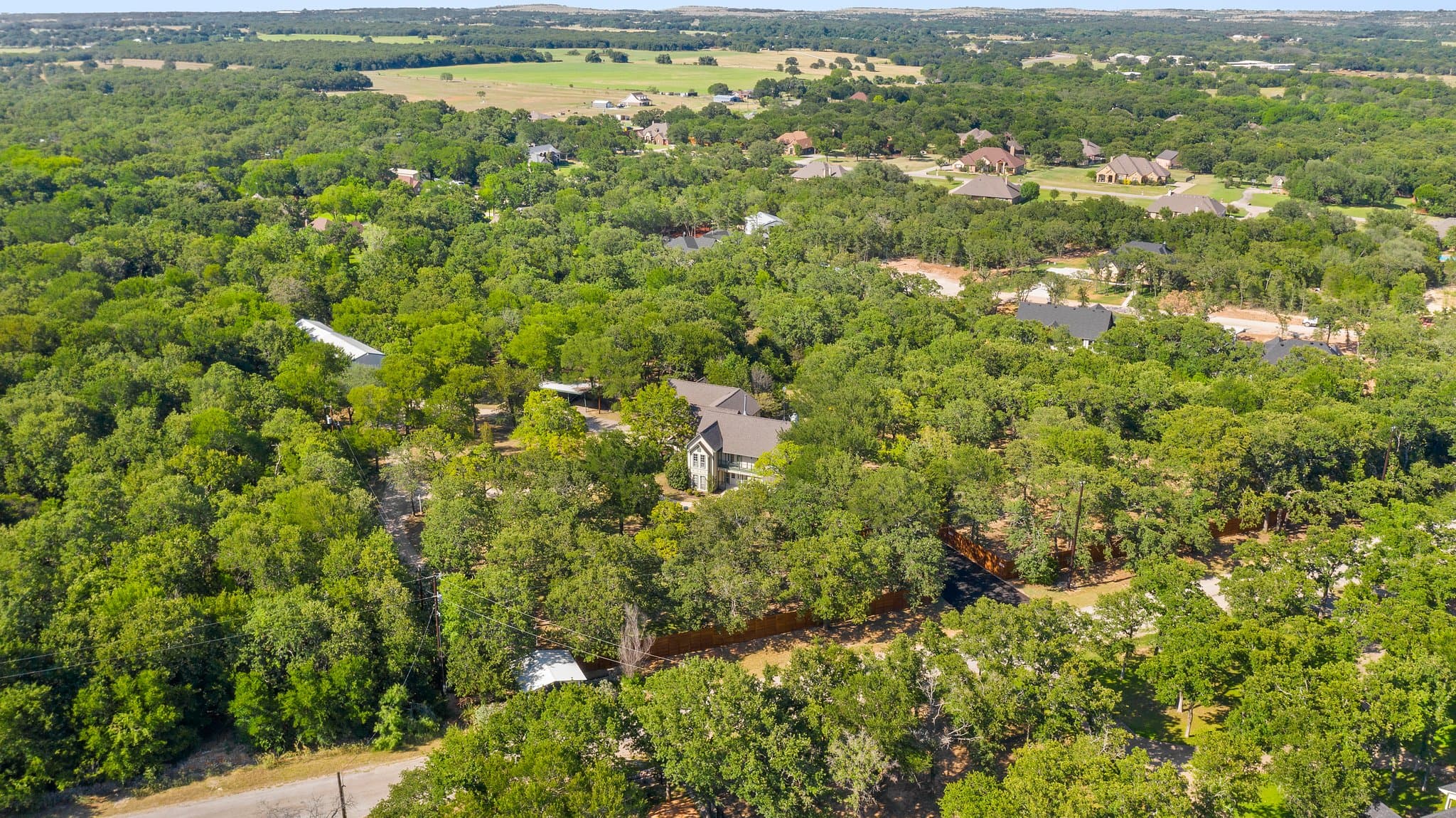 Aerial view over the wooded countryside surrounding the campus