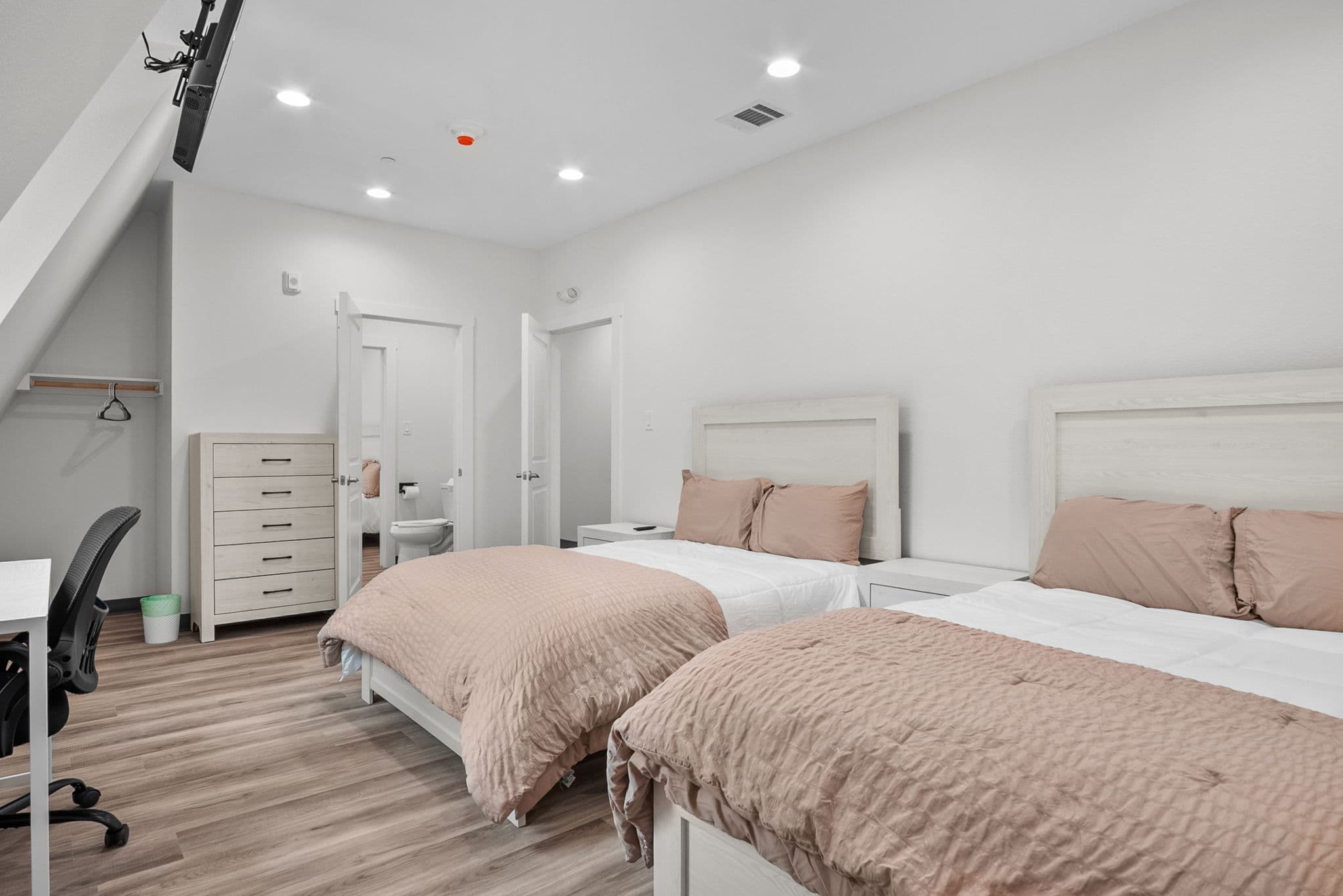 Two-bed room with a desk beneath the window