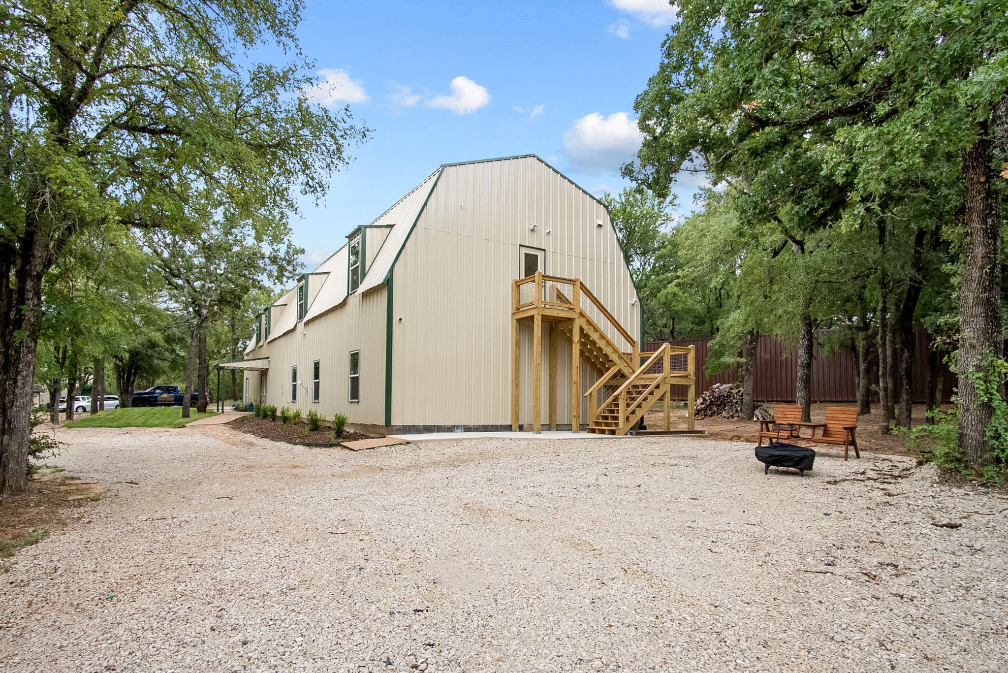 The barn residence seen from the gravel drive