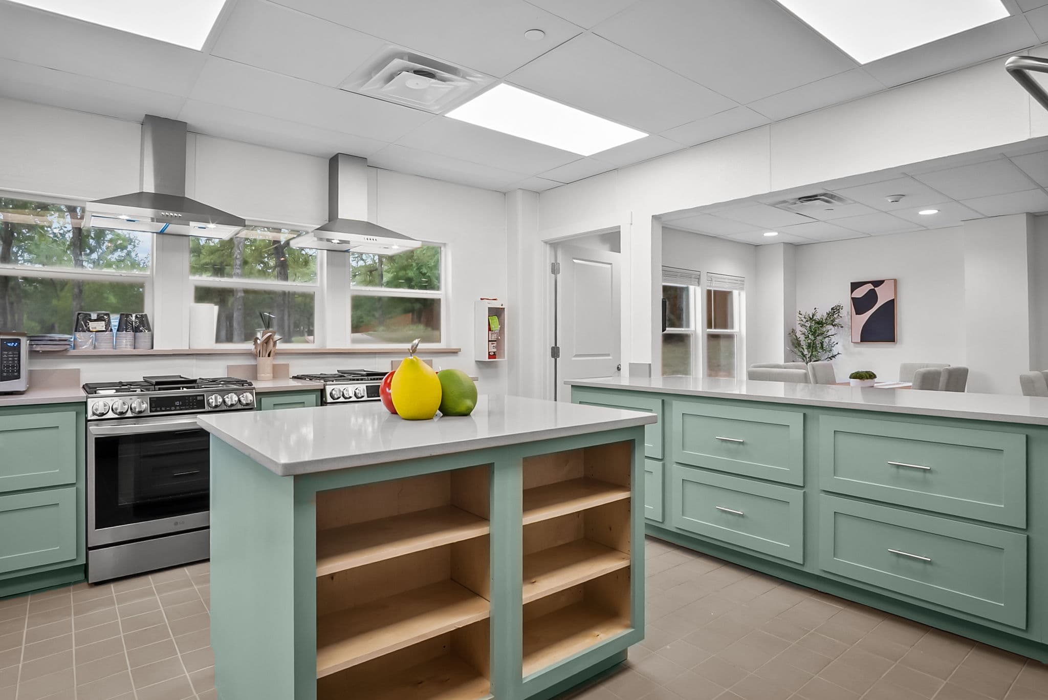 Kitchen with range and green cabinetry